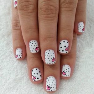 Valentine-nail-art-designs-with-single-pink-hearts-against-black-and-white